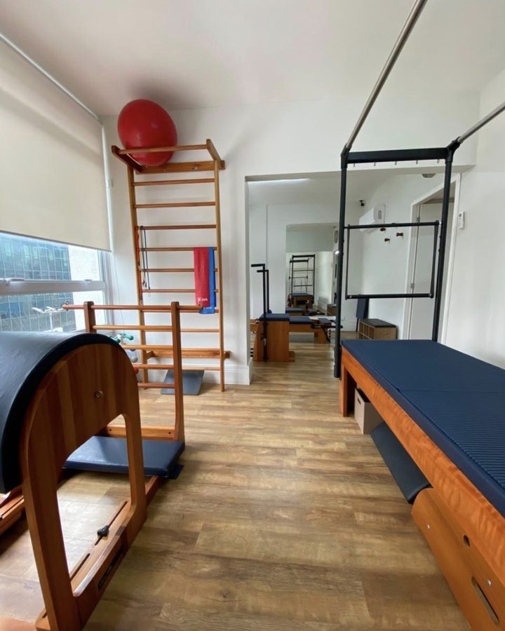 Estúdio de Pilates da clínica, com barrel, cadillac, reformer e escada sueca.
